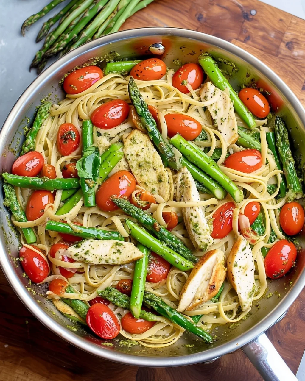 Plate of Asparagus Chicken Pasta with chicken pieces and asparagus spears