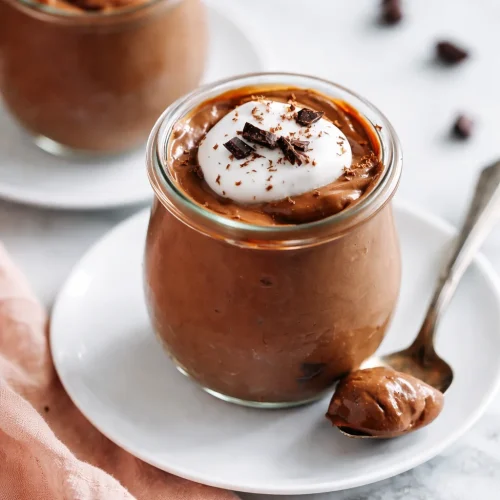 A delicious bowl of homemade vanilla pudding with whipped cream and berries