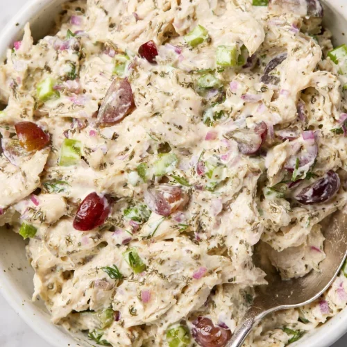 Delicious simple chicken salad recipe with mayo served in a bowl with fresh ingredients.