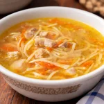Bowl of quick chicken noodle soup homemade with chicken, vegetables, and noodles.