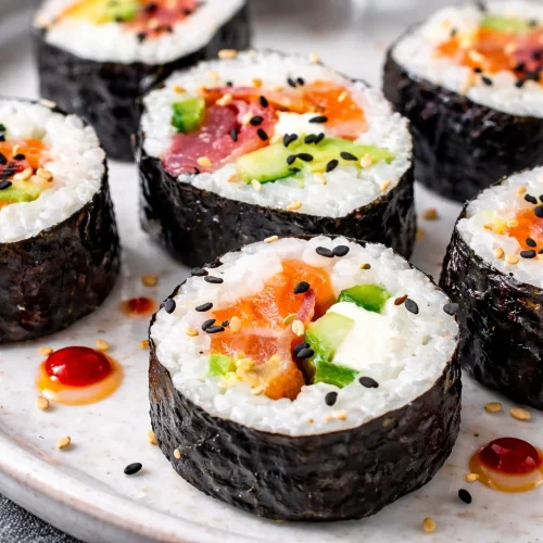 Homemade sushi rolls with various fillings and toppings.