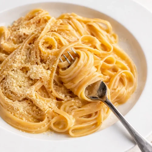 A simple pasta dish made with butter, garlic, and parsley, showcasing easy ingredients.